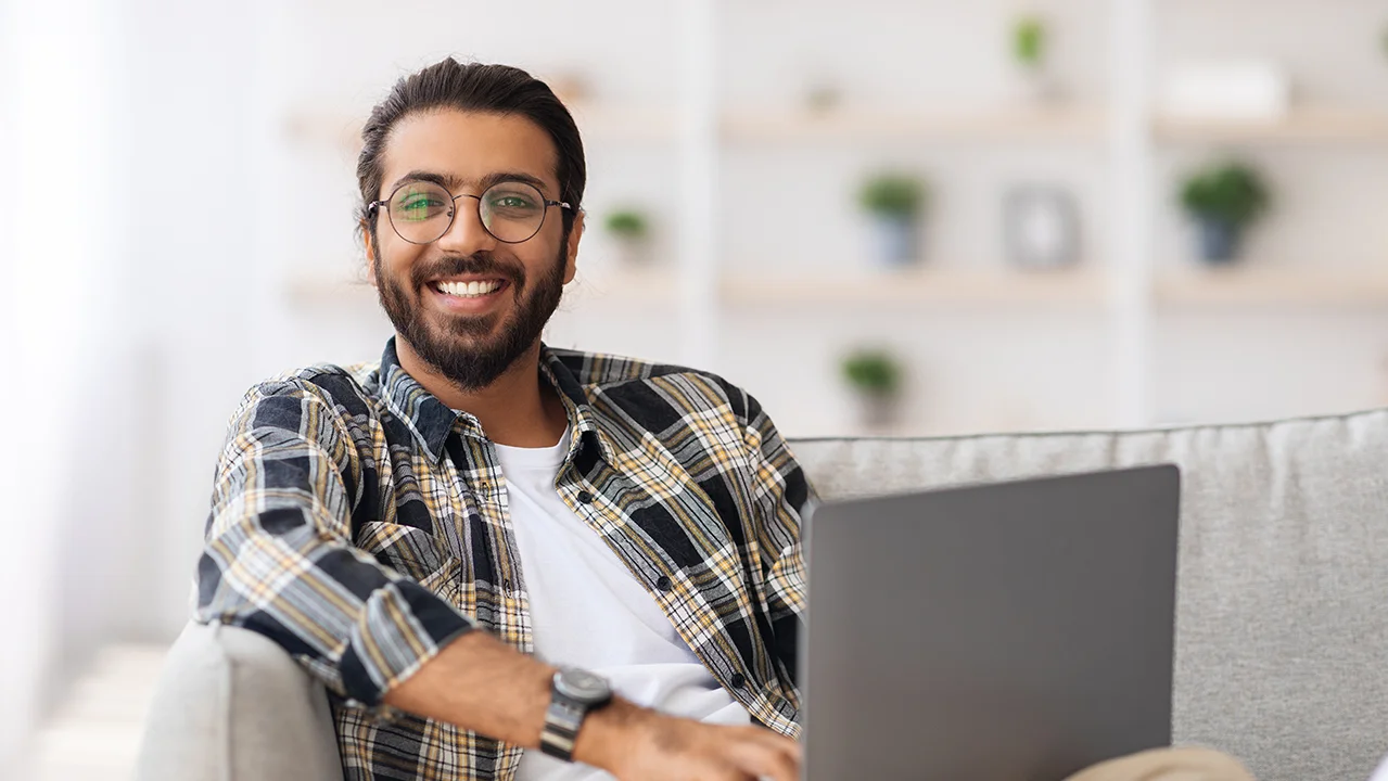 man-on-couch-with-laptop.webp
